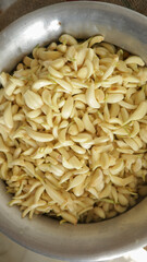 A silver pot full of peeled garlic before blending at home in Dhaka, Bangladesh.