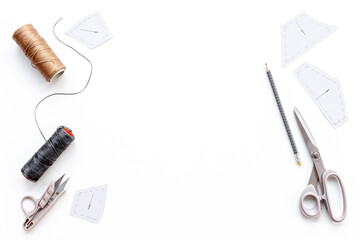 Tailoring scissors with bobbins of thread. Sewing background