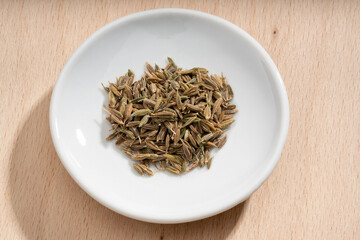 Fototapeta na wymiar Detailed and large close up shot of cumin on a small plate