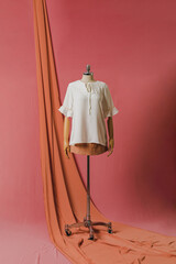 mannequin in a dress on a mannequin red pink background fashion still photography blouse skirt