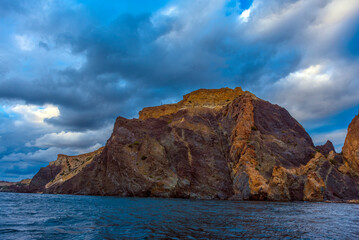 Fototapeta na wymiar rocks of Cape Fiolent against the background of the evening sky with clouds