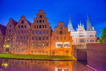 Holstentor gate at summer night with medieval city buildings in Lubeck, Schleswig-Holstein - Germany