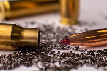 Isolate, macro photo of a bullet with a ballistic tip, on a white phoneme macro photo of a bullet...