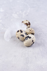 Easter minimal concept. Quail eggs with paper tag as easter symbol. Light grey marble background. Place for your text, copy space.