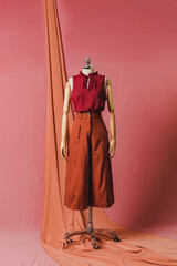 mannequin in a dress on a mannequin red pink background fashion still photography blouse skirt