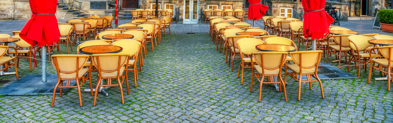 Beautiful city restaurant outdoor tables in summer season.
