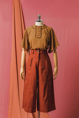 mannequin in a dress on a mannequin red pink background fashion still photography blouse skirt
