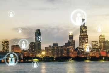 Double exposure of social network icons hologram on Chicago office buildings background. Networking...