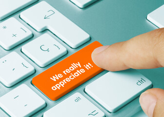 We really appreciate it - Inscription on Orange Keyboard Key.