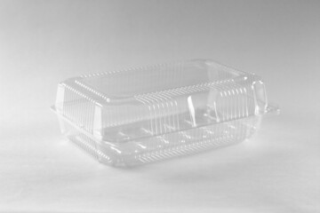 Transparent plastic container. Close up. Isolated on grey background