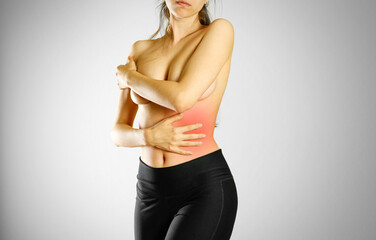 A young girl with no shirt holding hand of a sick stomach. Pain in the abdomen. The pain is marked...