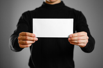 Man showing blank white flyer brochure booklet. Leaflet presentation. Pamphlet hold hands. Man show...