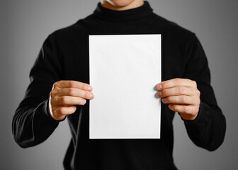 Man showing blank white flyer brochure booklet. Leaflet presentation. Pamphlet hold hands. Man show...