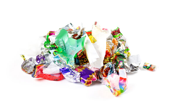 A bunch of candy wrappers on a white background. Closeup