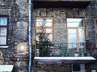 Gray brick wall building facade with balcony and windows