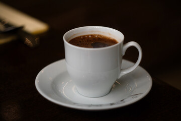 Porcelain cup of strong morning black coffee in Arabian style