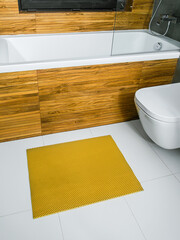 A rubber mat on the floor next to the bathtub in the bathroom. Interior design, modern bath - 488566264