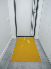rubber door mat, front door, home with traces of dirt and snow - 488566284