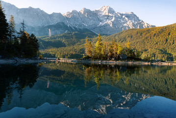 Impressive summer sunrise at Eibsee lake with Zugspitze mountain. Sunny outdoor scene in German Alps, Bavaria, Germany, Europe. Panorama Eibsee lake in the Alps. 