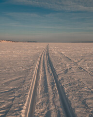 the snowmobile left behind a long strip in the snow	