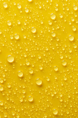 Drops of water on a yellow background.