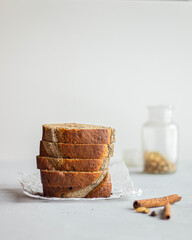 Slised banana cake on light background nearby cinnamon and cardamom