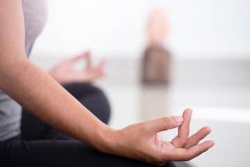  Woman practicing yoga in the bedroom,Lotus pose with mudra gesture,Mindfulness.