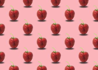 Strawberries on a pink background. Seamless pattern with ripe red strawberries.