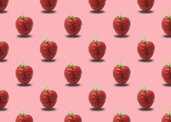 Strawberries on a pink background. Seamless pattern with ripe red strawberries.