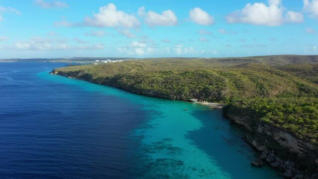 Aerial view of the coast of Curaçao in the Caribbean Sea with turquoise water, cliff, beach, and beautiful coral reef around Vaersenbay