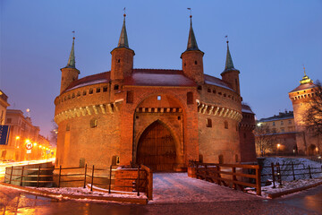 Fototapeta premium Defensive tower of the Barbican in winter evening is the gate of the medieval Krakow, Poland