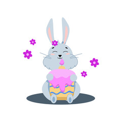gray easter bunny sits with a cake with a candle