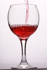 red wine pours into the glass