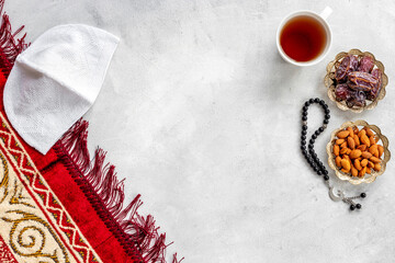 Ramadan Kareem concept. Islamic prayer carpet with rosary and dried fruits