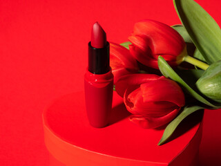 Obraz na płótnie Canvas Red lipstick, tulips on heart box for womens, valentines day