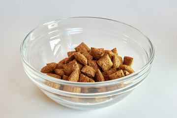 Granola in a transparent bowl on a white background. Healthy food.