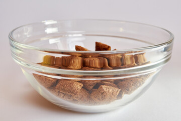 Granola in a transparent bowl on a white background. Healthy food.