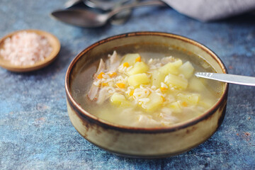 A bowl with chicken soup with pasta
