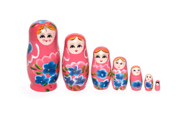 Pink colored nesting dolls on a white background. Russian national souvenir.