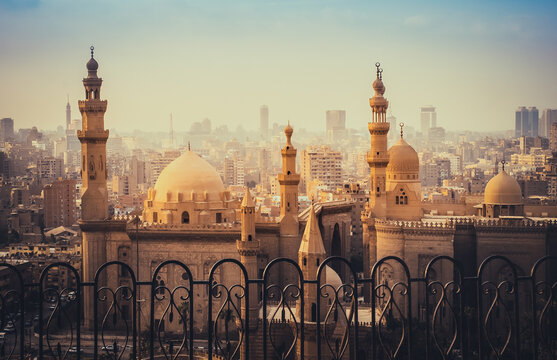 Mosque of Al Rifai and Madrasa of Sultan Hassan in the  Cairo old city. Cityscape scene with ancient muslim architecture with minarets at sunset.