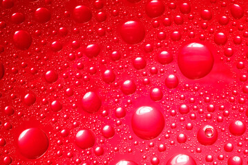 Abstract red background. Liquid on glass.