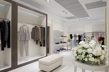 Fototapeta na wymiar Women fashion clothing and accessories store display. Fashion shop interior in shopping mall.