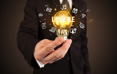 Businessman holding a light bulb, social media concept