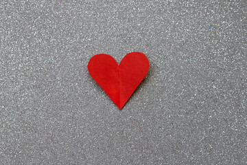 red heart paper on silvery background