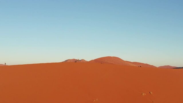 Aerial drone footage of Dune 45 in Sossusvlei, Namibia during sunset
