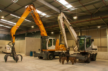 Two bulk handler mobile cranes in a warehouse