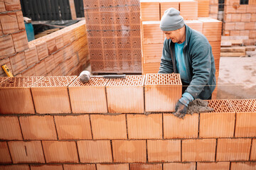 Professional worker building brick walls