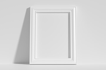 Vertical rectangular photo frame on floor leaning at wall