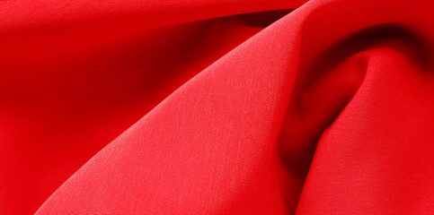 Red silk satin background. Luxurious background design. Copy space for text. Valentine, Christmas.