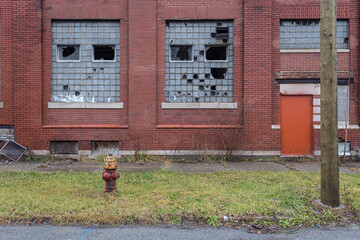 Abandoned warehouse with broken frosted glass and vintage fire hydrant